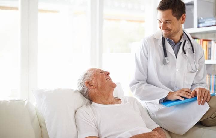 Elderly male senior citizen talking with a doctor.