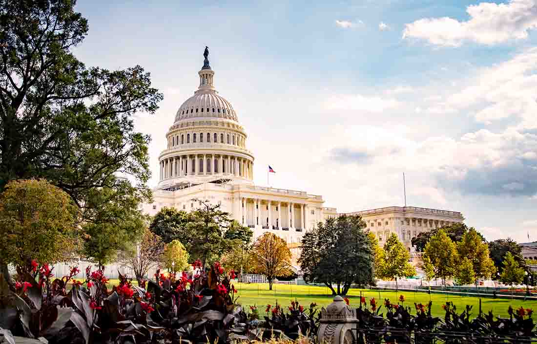 View of the U.S. capitol building with the sun shining on it.