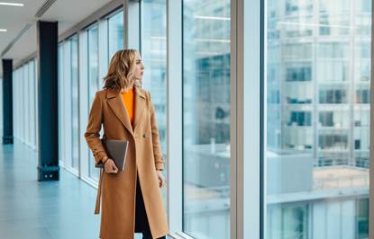 Real estate professional looking out of an office window.