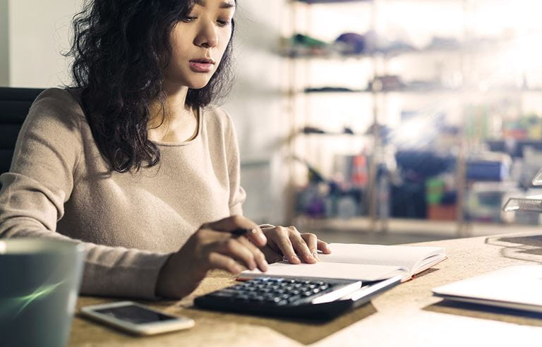 Woman using calculator