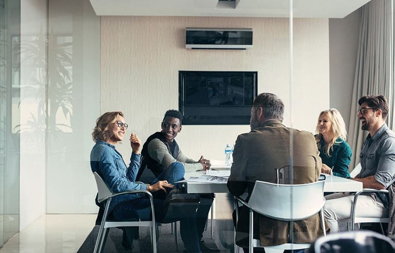 Group of people in a glass meeting room