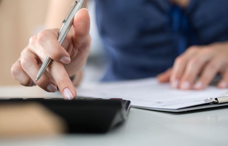 Image of woman using calculator