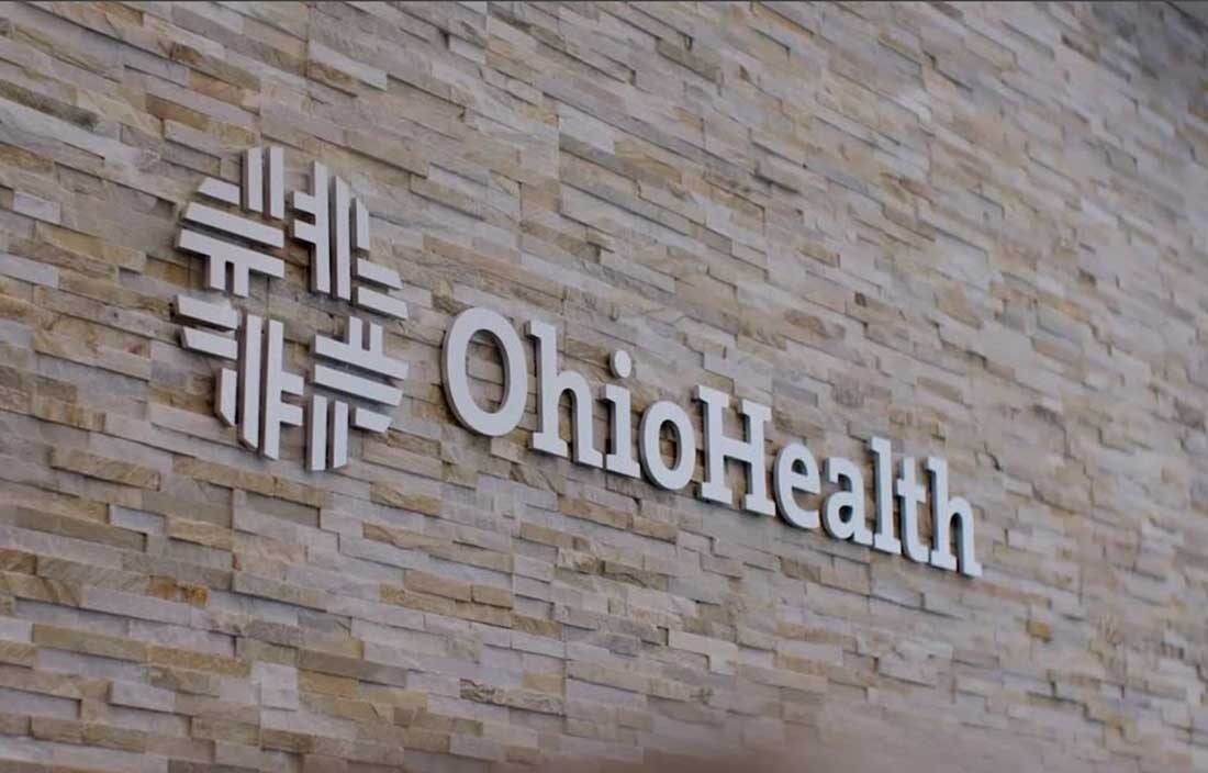 Close-up photo of OhioHealth's sign and logo on the side of a brick wall