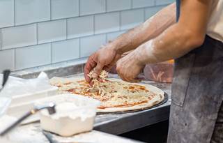 Chef making pizza.