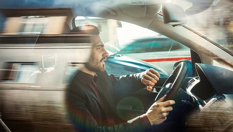 Businessman rushing to a meeting in his vehicle