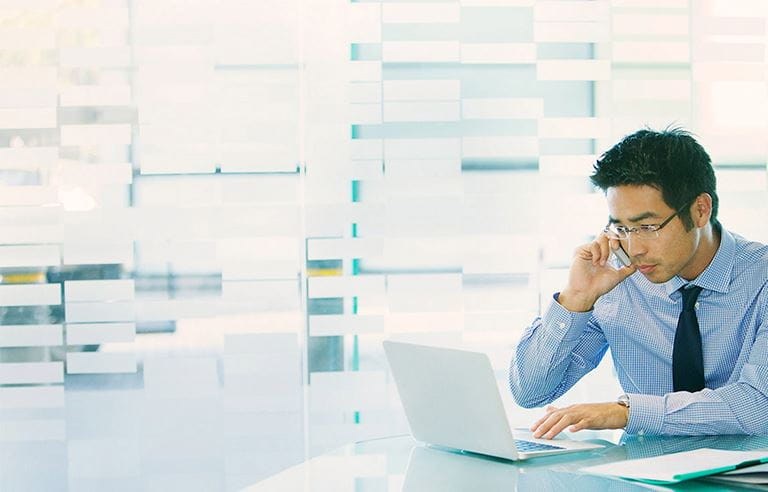 Man viewing laptop at desk