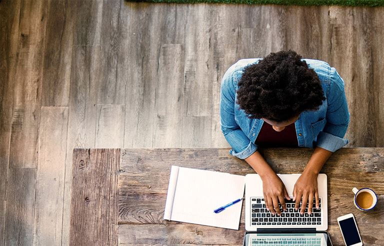 Top view of woman working on laptop