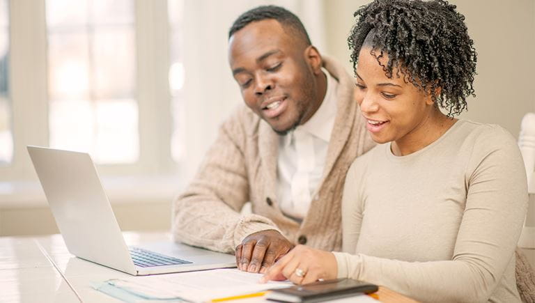 African American couple working on a laptop together 