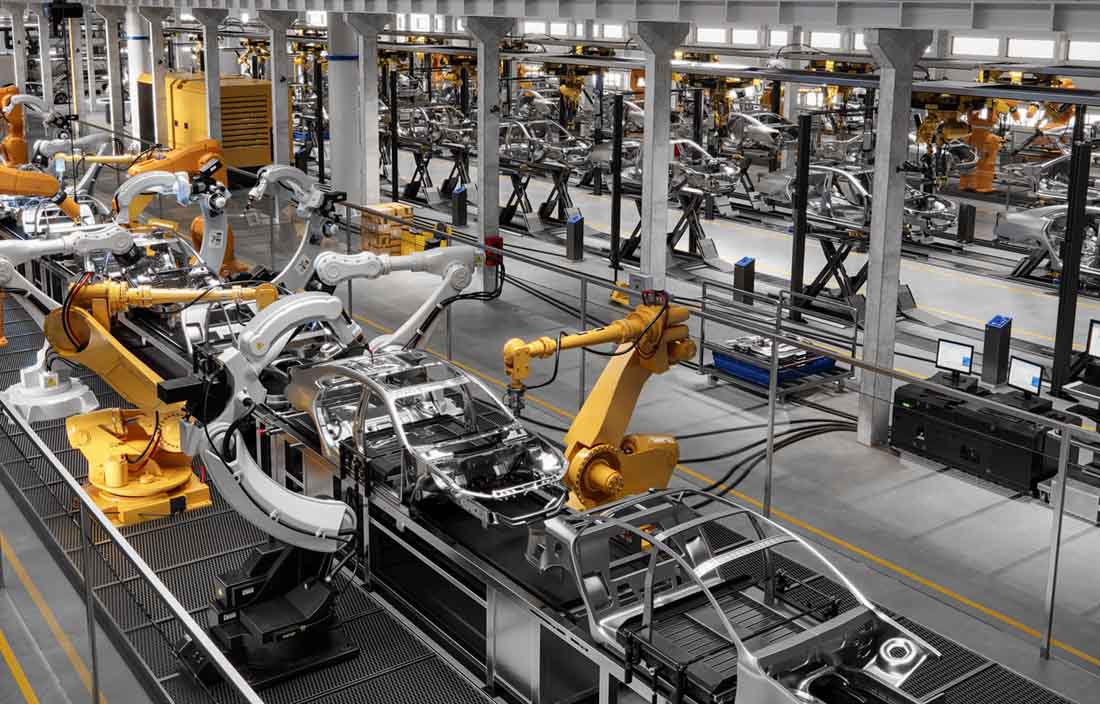 Software-defined vehicles being manufactured in an automotive assembly line.