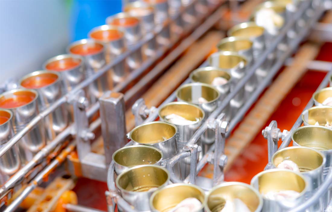 Aluminum cans on an assembly line at a factory.