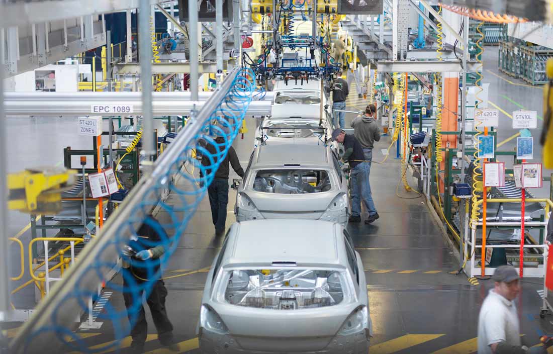 Cars in an assembly line at a factory.