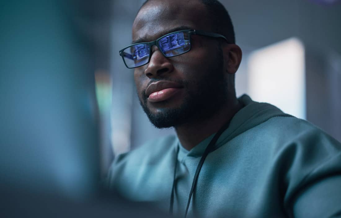 Cybersecurity professional looking at their laptop.
