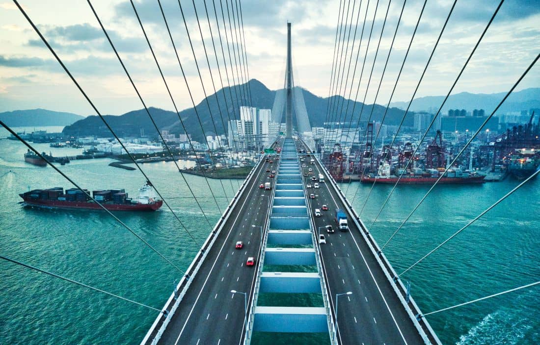 Aerial view of bridge and ships crossing.