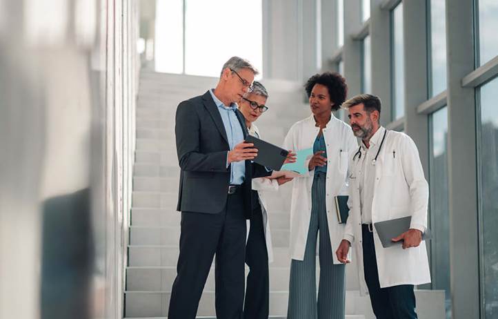 Doctors reviewing medical information in a hallway.