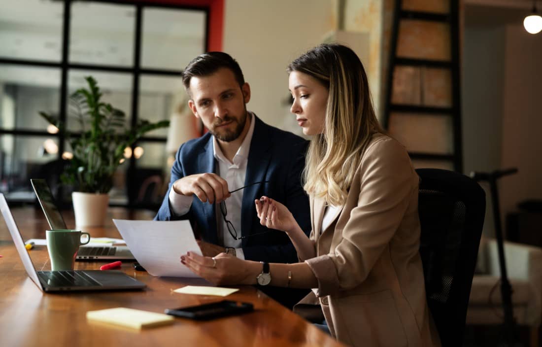 Two tax professionals reviewing 2027 compliance guidelines.