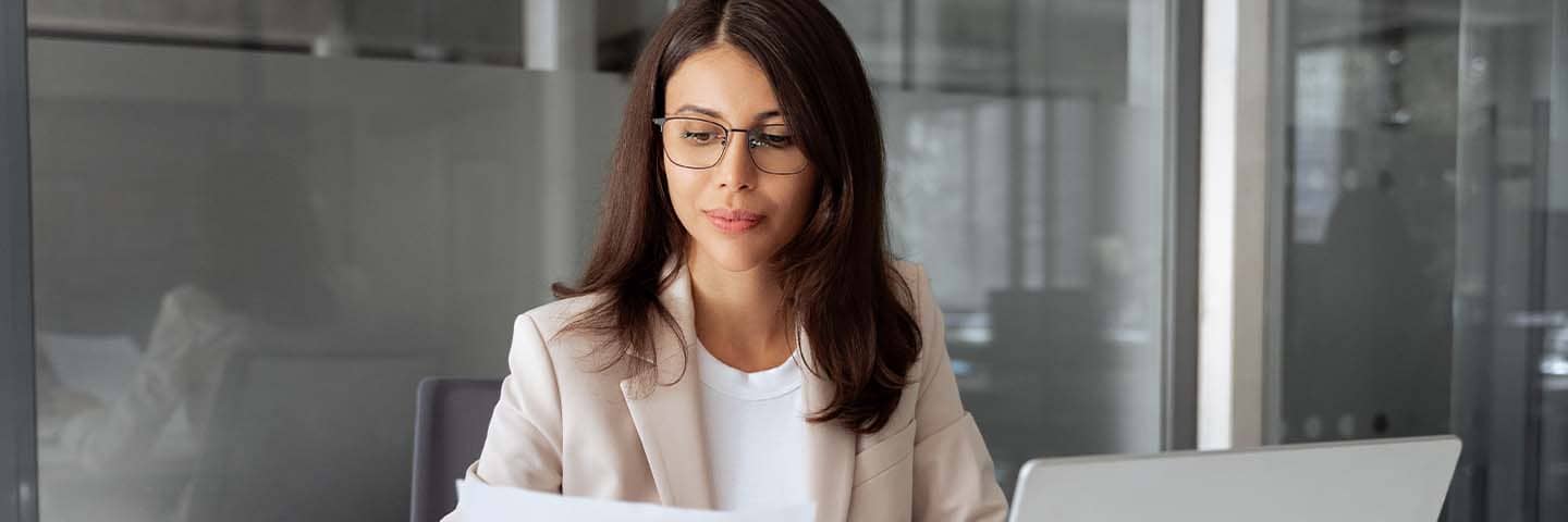 Business professional looking at documents at work.
