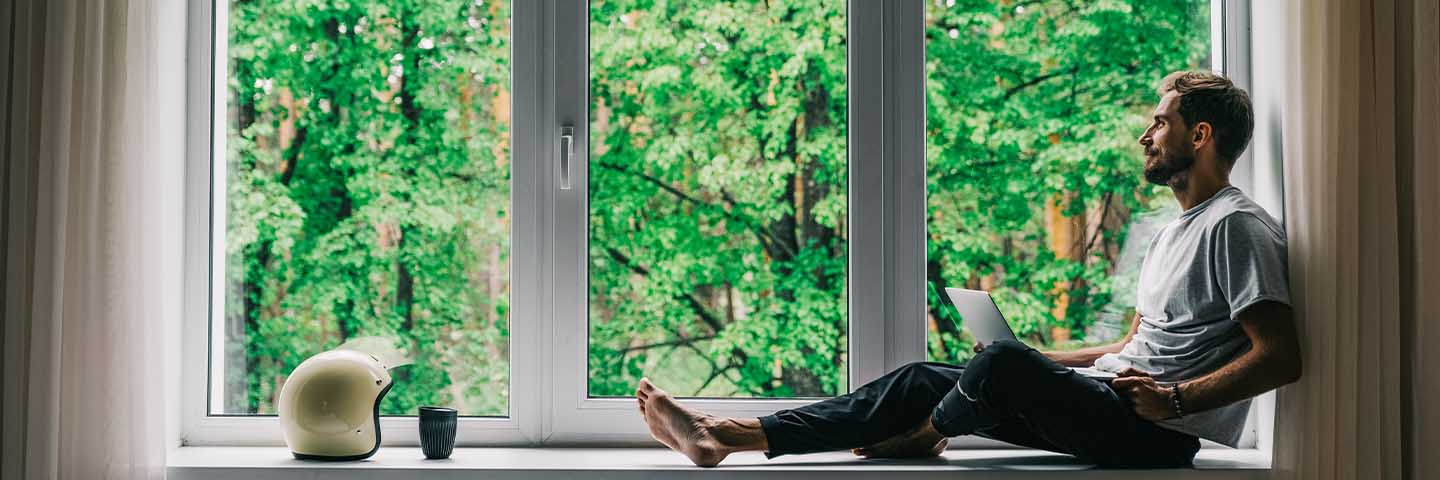 Person sitting on a windowsill.