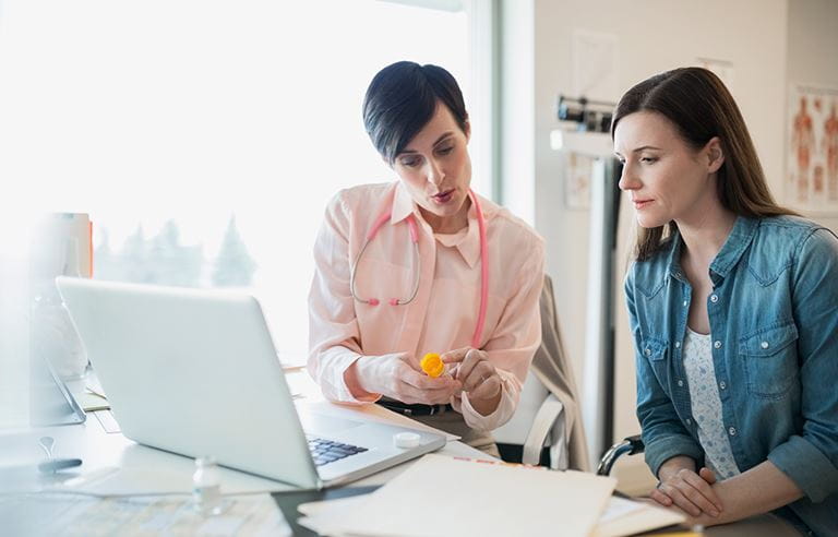 two women discussing medication options