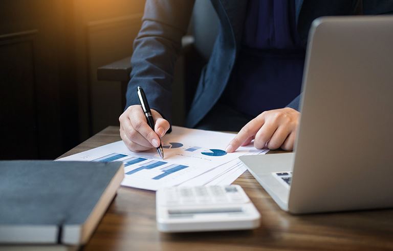 Photo of man working on tax paperwork. 