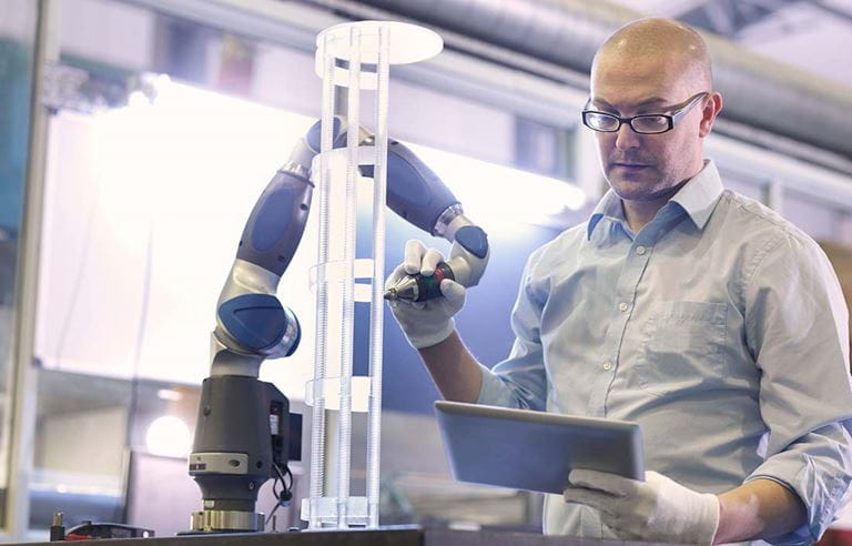 Man using futuristic manufactuing machine. 