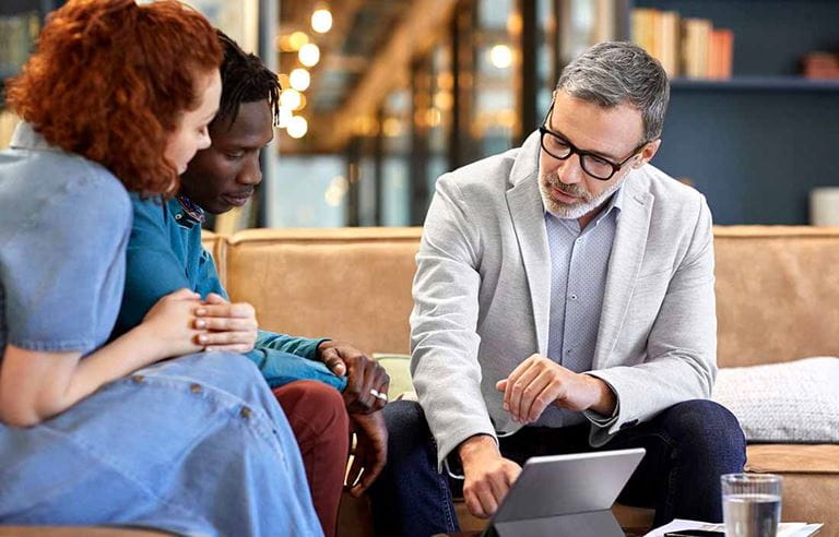 Professional trustee advising a young couple.