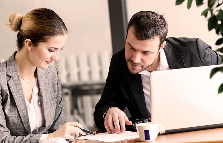 Image of business people working together at computer