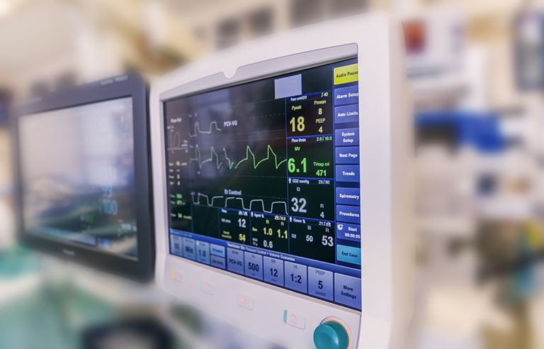 Image of patient diagnostic equipment in a hospital room.