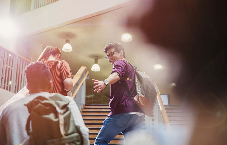 Image of college students walking up a flight of stairs.