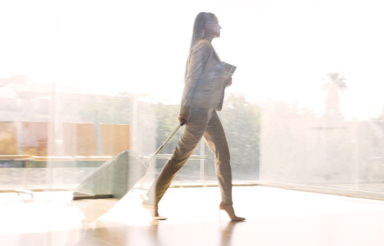 Person walking with documents 