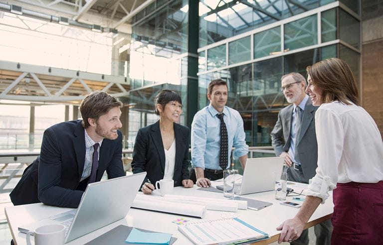 Image of business people talking around a table