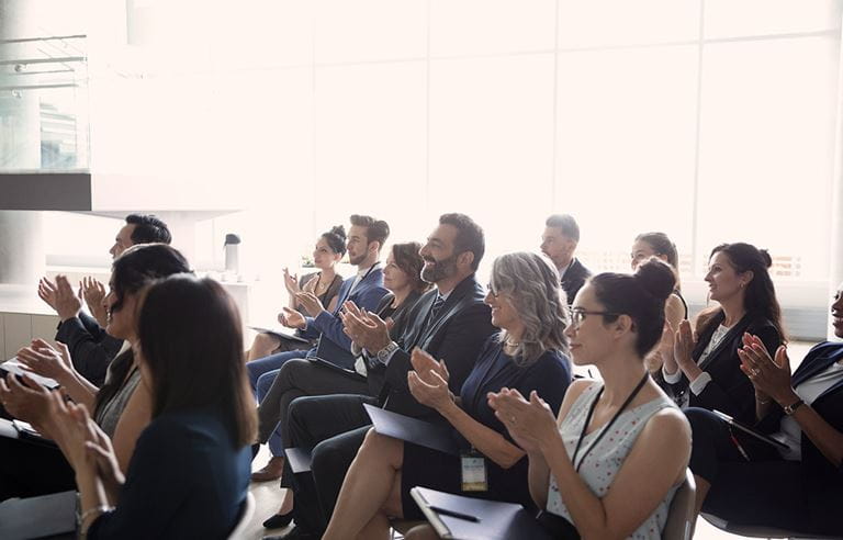 people clapping at a conference 