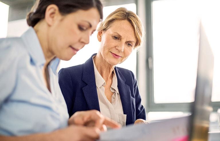 Hospital data being reviewed by staff in front of computer