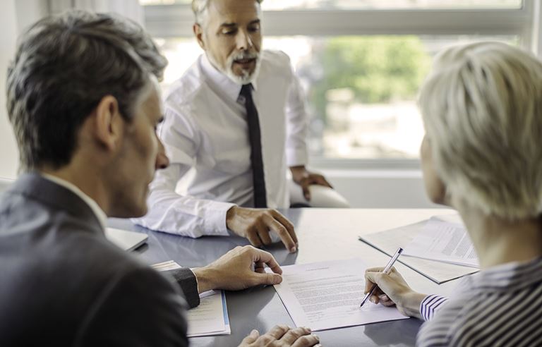 Adults talking over a desk