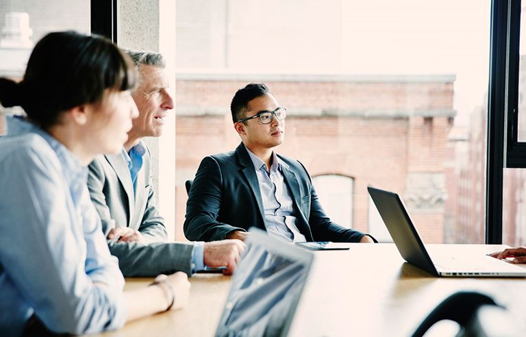 Three professionals in a business meeting