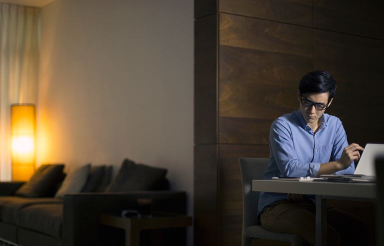 Man sitting at a desk reading