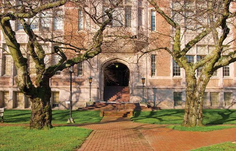 Outside of an old brick building with trees.