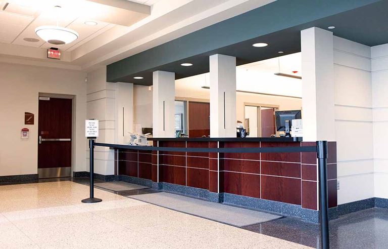 Interior of a bank with a view of the bank teller counter.