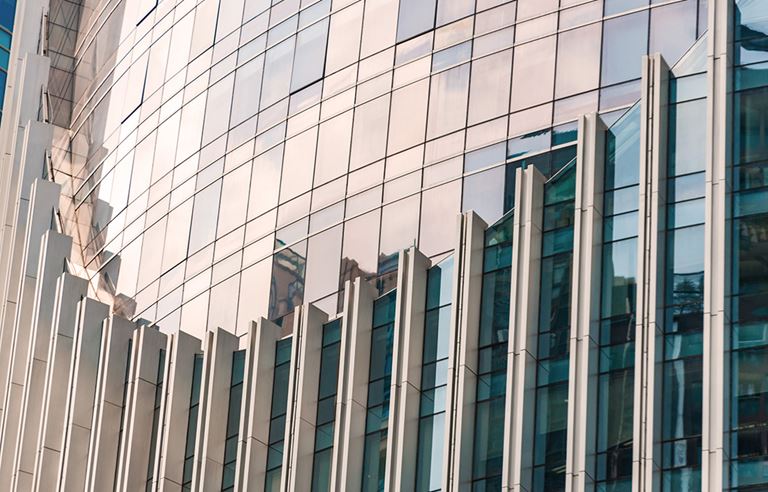 Close-up photo of the side of a building with curved architecture.