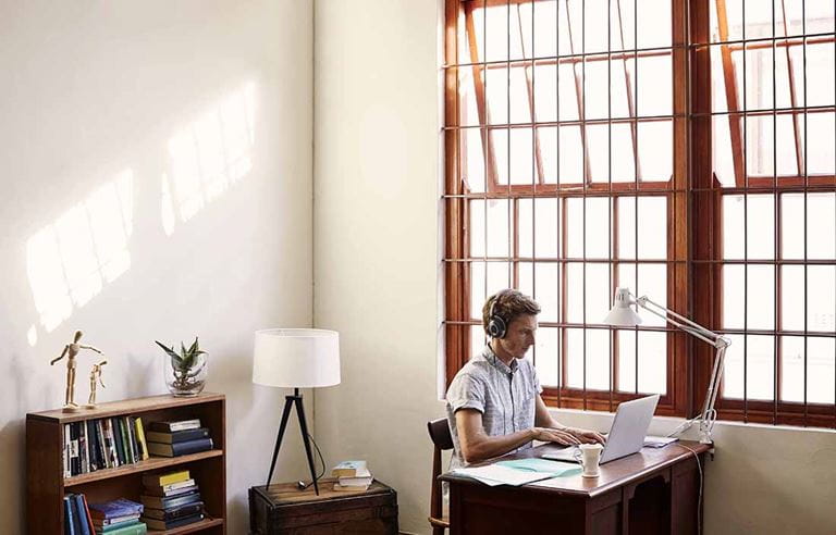 Businessman working in home office in casual business clothing.