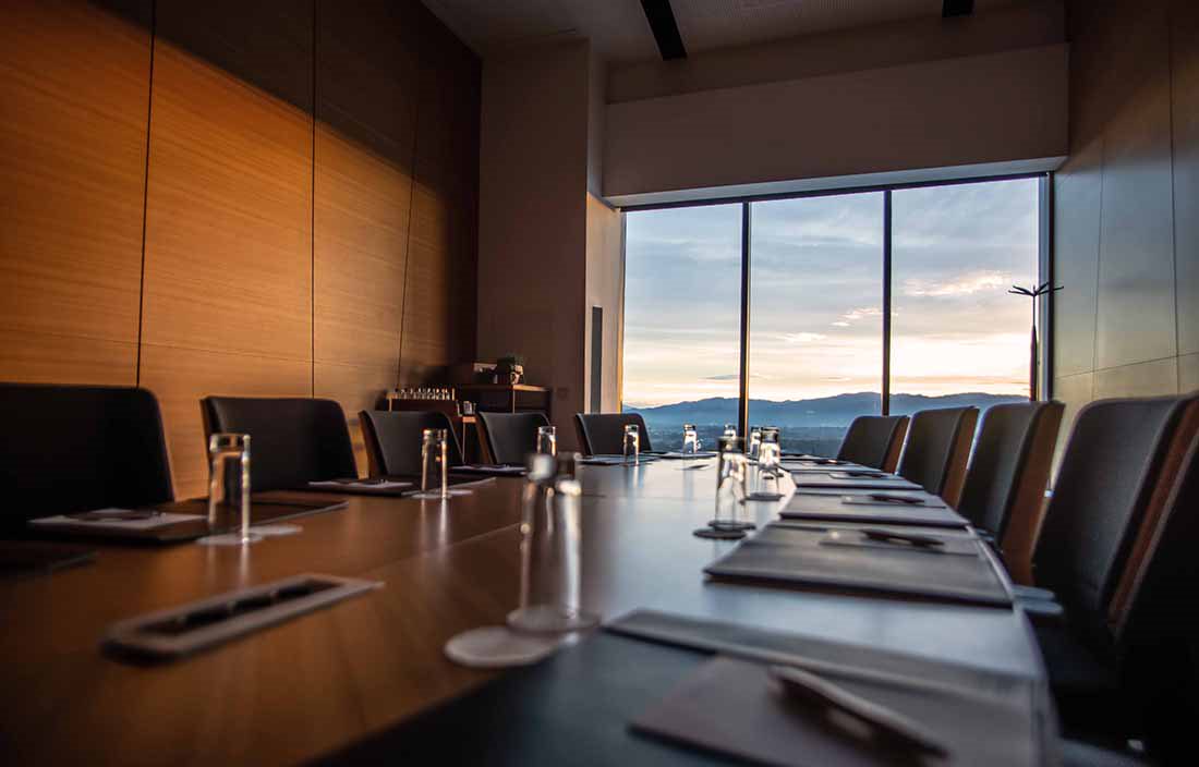 View of an empty conference room with a large wooden table.