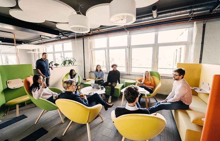 Business professionals meeting in a modern company cafe area.