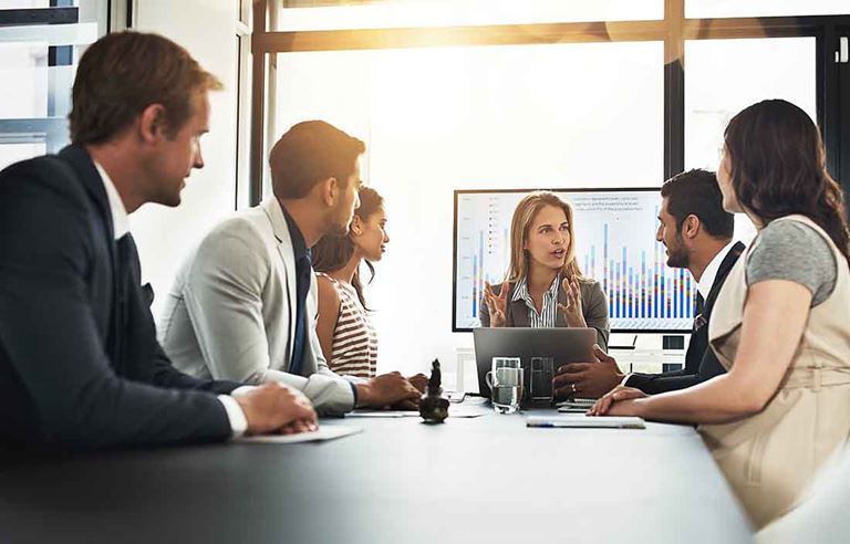 Business professionals holding a meeting in a conference room.