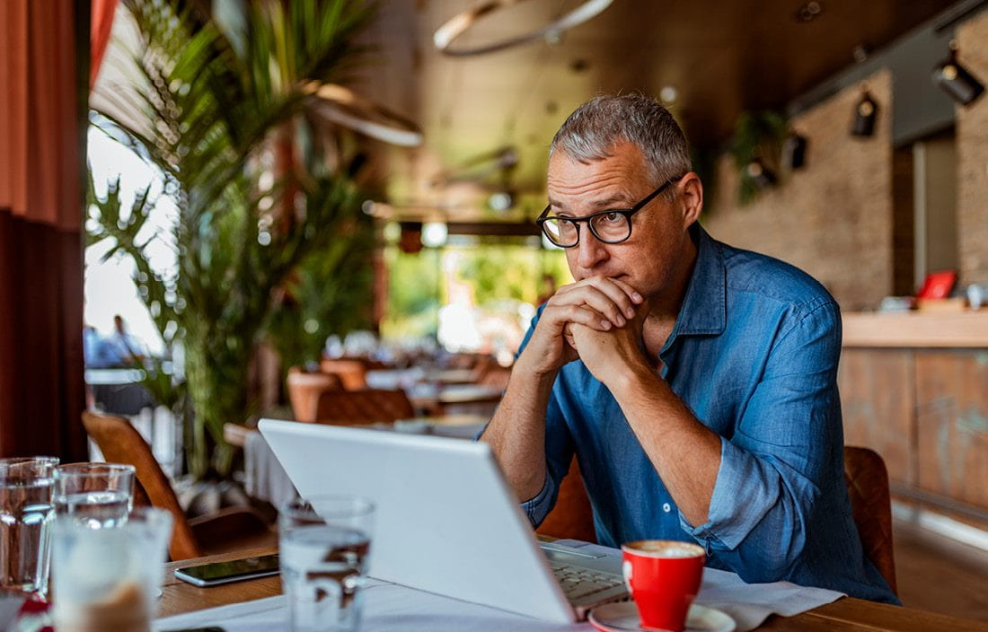 Person sitting and thinking in coffee shop.