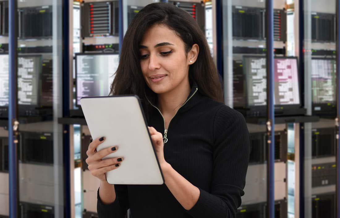 Person on tablet computer in technology room.