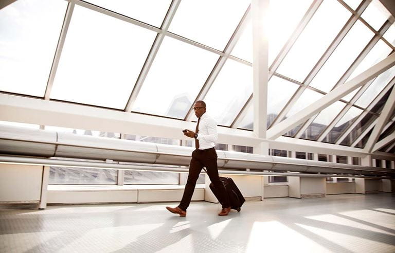 Business professional walking through an airport.