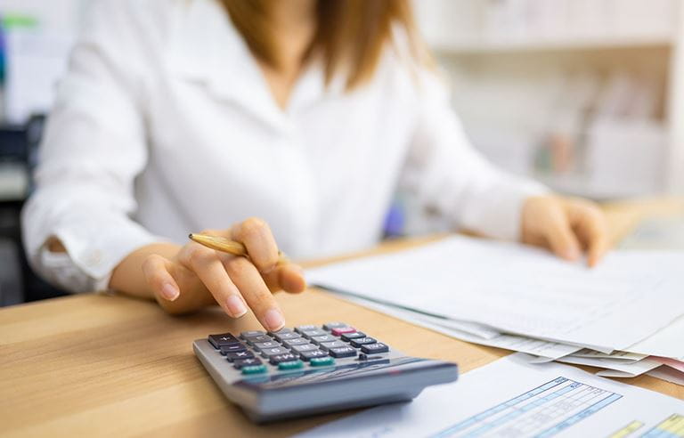 Person using calculator to work on taxes.