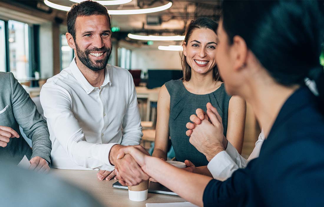 Family office professionals greeting their advisor.