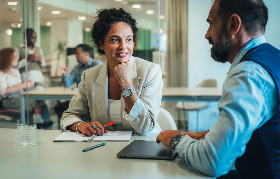 Two public sector professionals discussing the OMB 2024 Compliance Supplement.