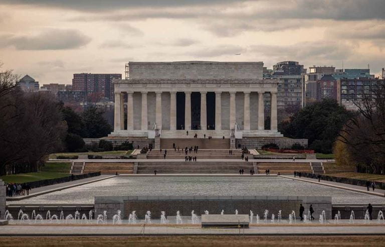 View of U.S. government building against a stormy sky.