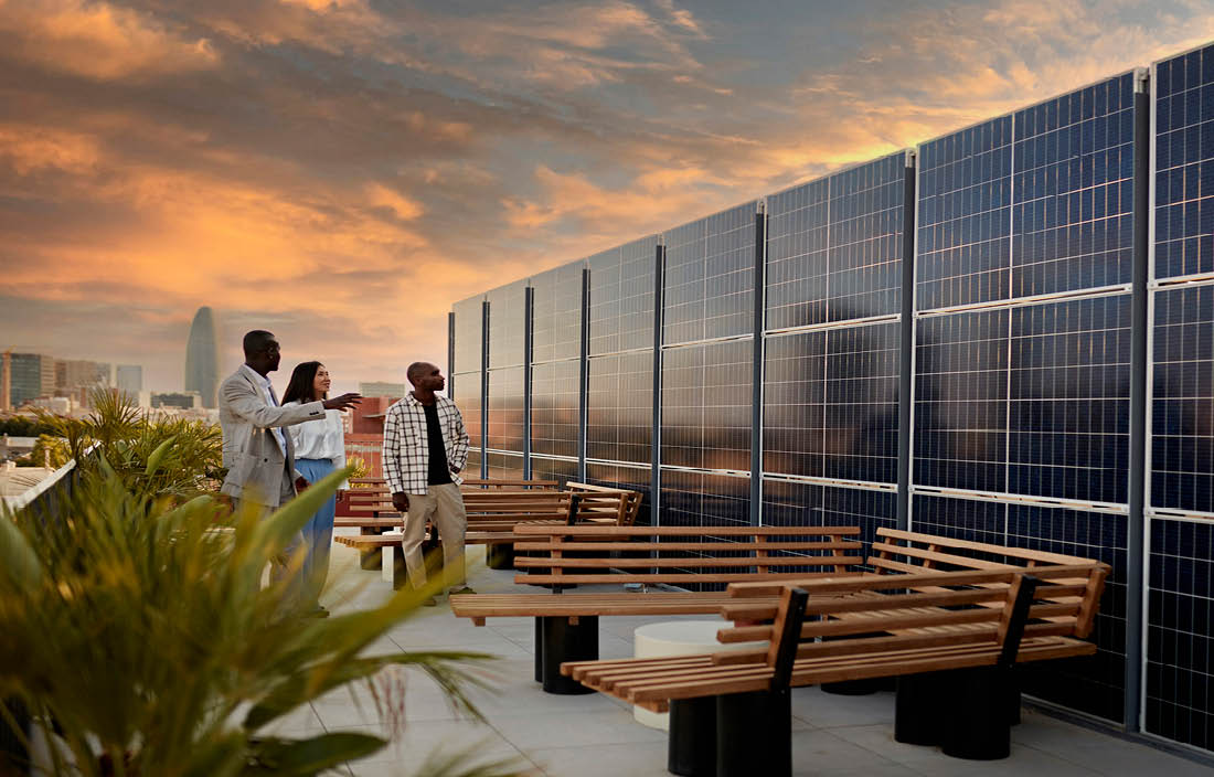 Business professionals looking at solar panels on a deck during dusk.